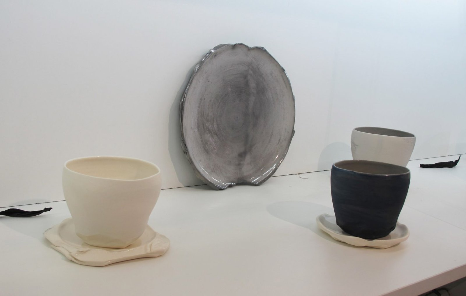 Black platter with cups and saucers